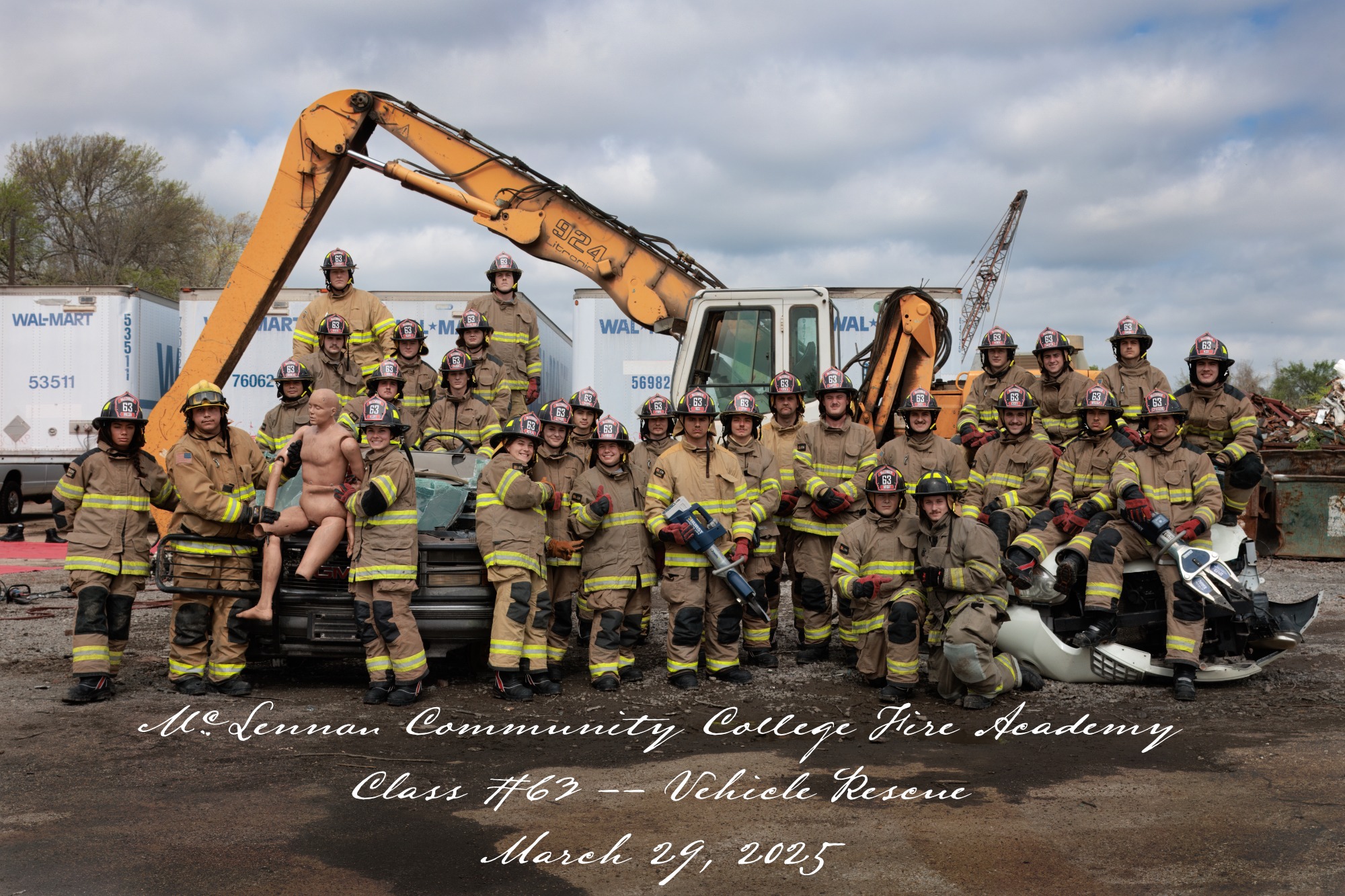 McLennan Community College Fire Academy Class #769 poses for a group photo in firefighting gear, featuring a vehicle rescue demonstration on March 29, 2025.