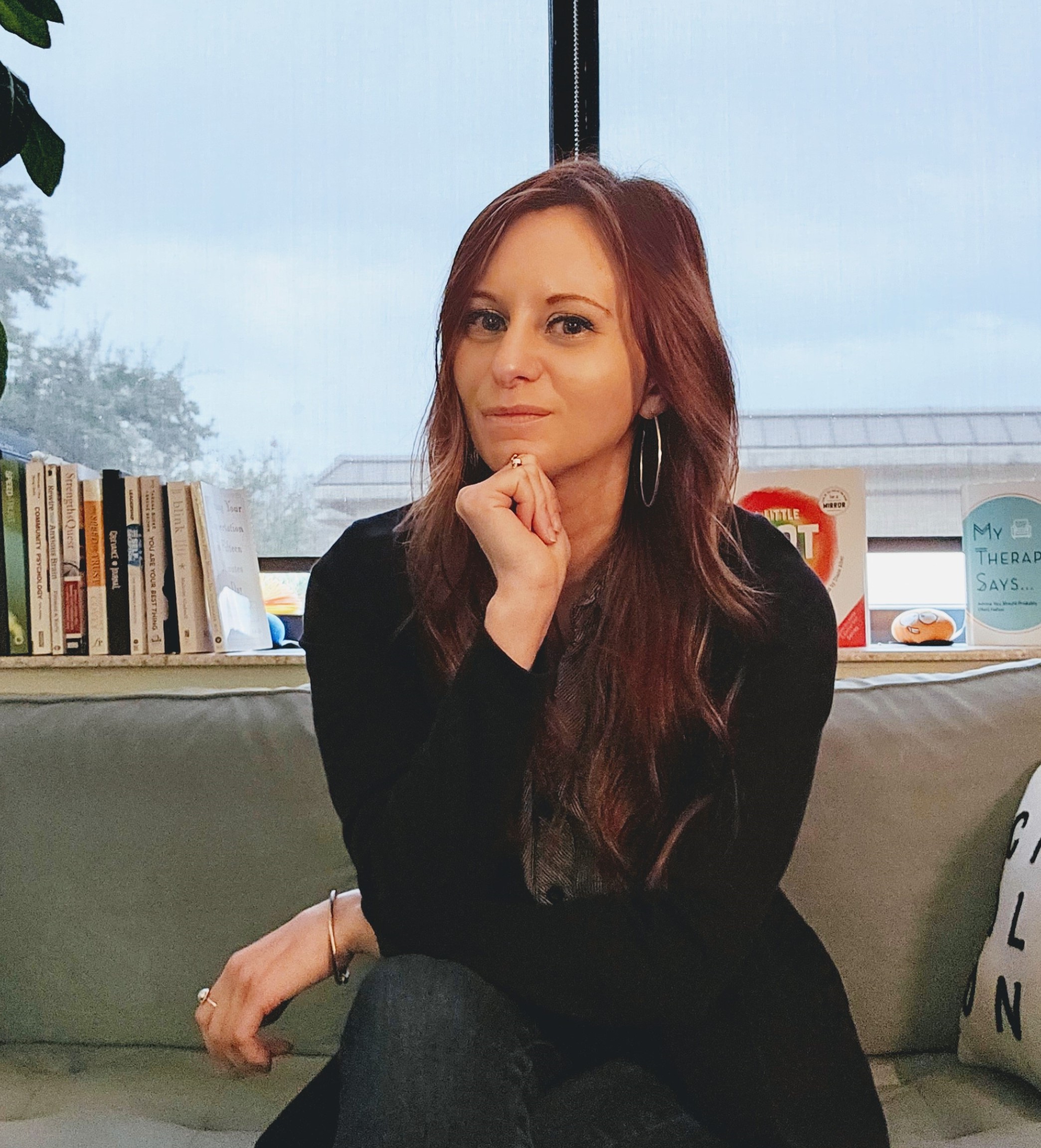 Katie Vise sitting on couch in her office. 