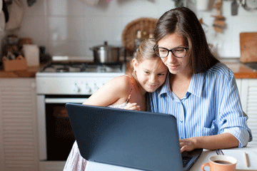 Mother with daughter at computer