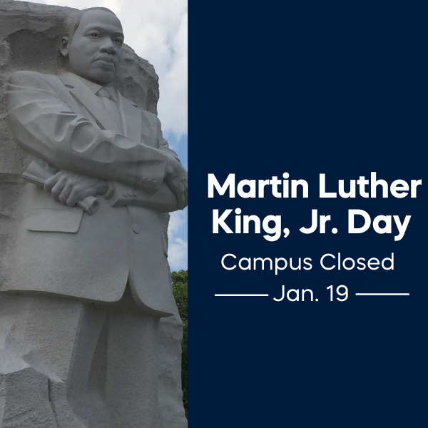 Stone statue of Martin Luther King Jr. with arms crossed, holding a rolled document, set against a cloudy sky. To the right, dark blue background with white text reads: “Martin Luther King, Jr. Day. Campus Closed. Jan. 19.”