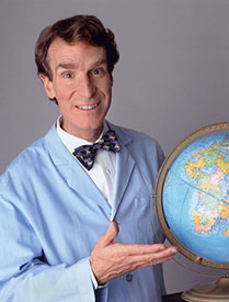 A smiling man in a lab coat holding a globe, promoting a sense of curiosity about science and geography.